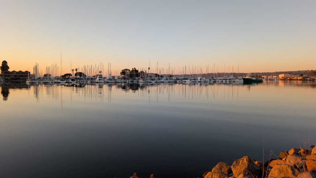 A harbour scene with small boats and a clear sky.