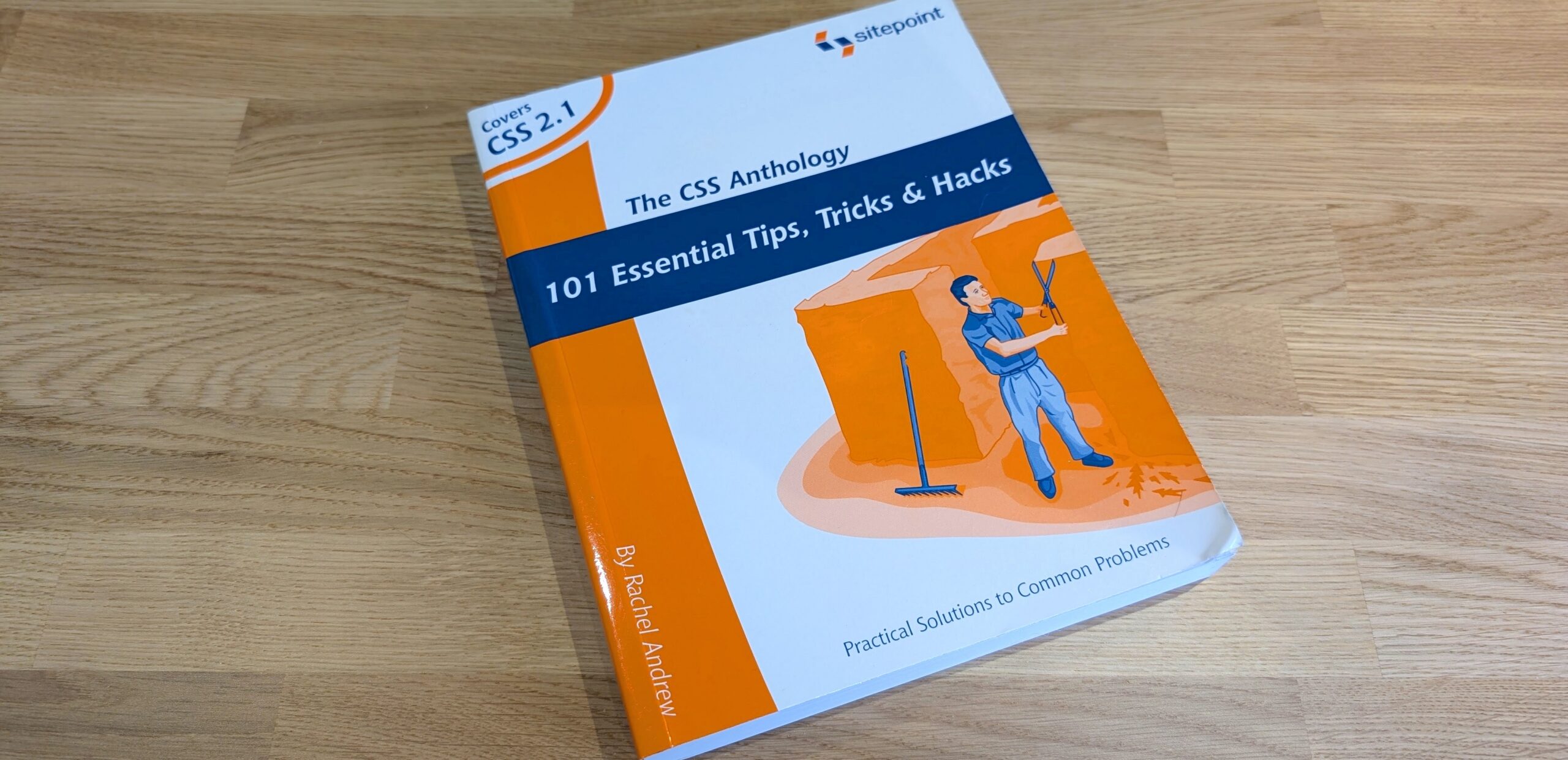 The CSS Anthology book on a wooden desk.